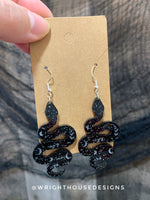 Load image into Gallery viewer, Celestial Snakes - Witchy Halloween Earrings - Engraved Glitter Black Acrylic Handmade Jewelry
